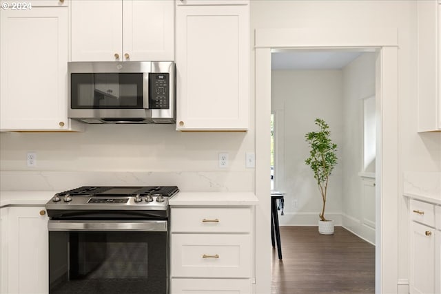 kitchen featuring white cabinets, stainless steel appliances, and dark hardwood / wood-style floors