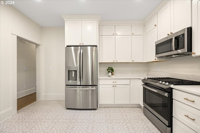 kitchen with appliances with stainless steel finishes and white cabinets