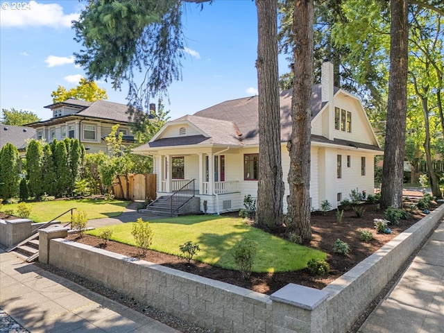 view of front of house with covered porch and a front lawn