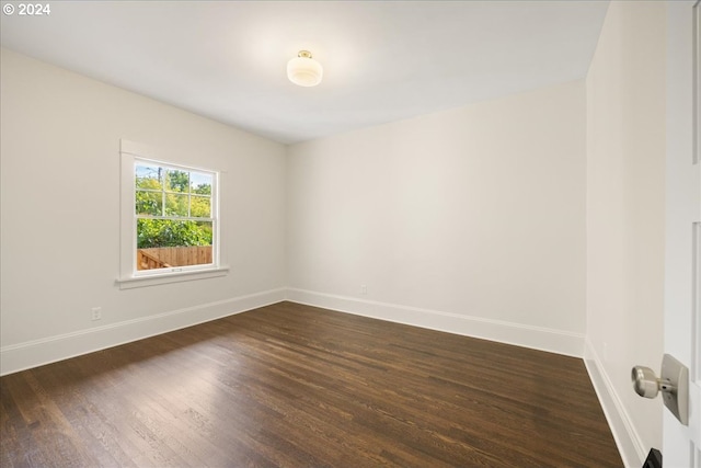 empty room featuring dark hardwood / wood-style flooring