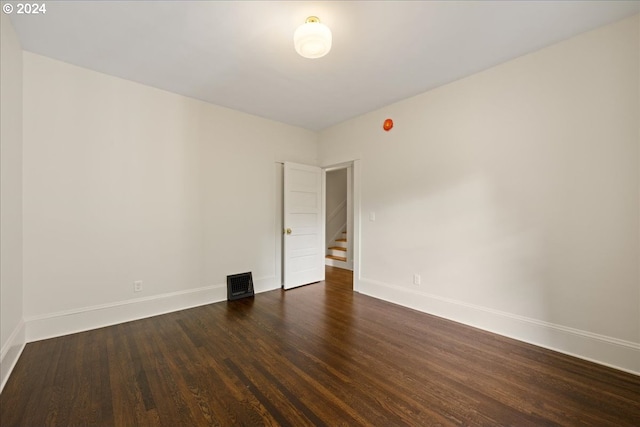 empty room with dark wood-type flooring