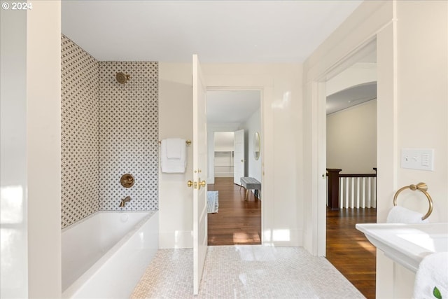 bathroom with shower / washtub combination and wood-type flooring