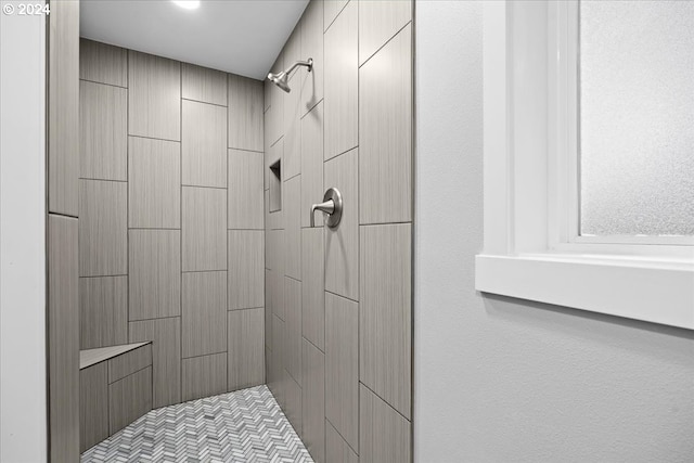 bathroom with tiled shower