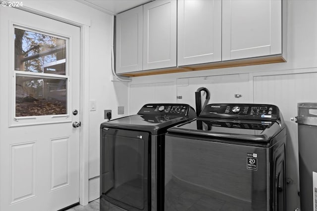 washroom with cabinets and separate washer and dryer