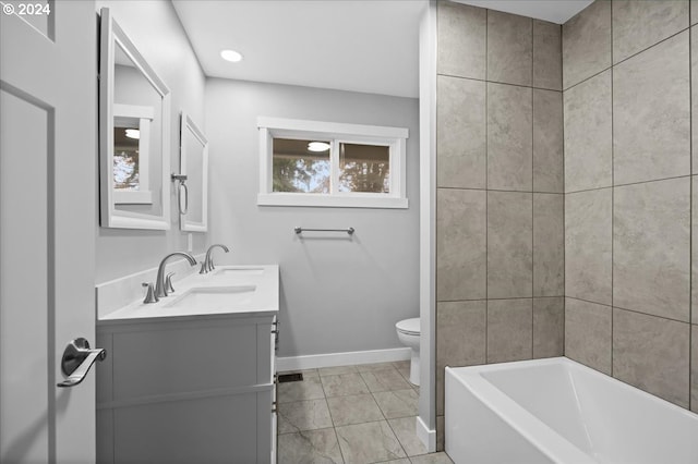 bathroom with tile patterned flooring, vanity, and toilet