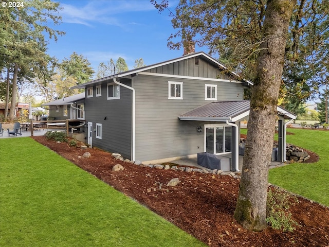 back of house featuring a yard and a patio