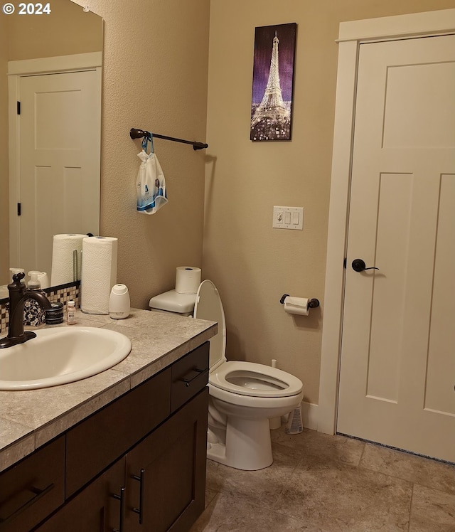 bathroom featuring toilet and vanity