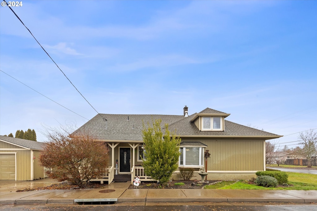 view of front of home featuring a garage and an outdoor structure