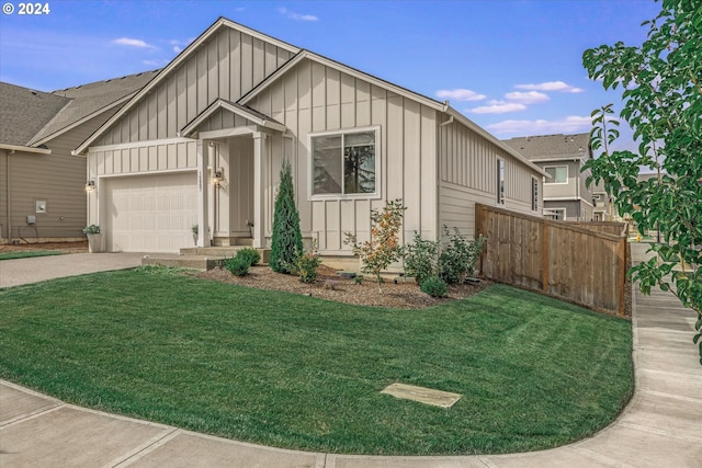 view of front of house featuring a garage and a front lawn