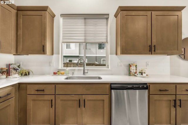 kitchen with dishwasher, decorative backsplash, and sink