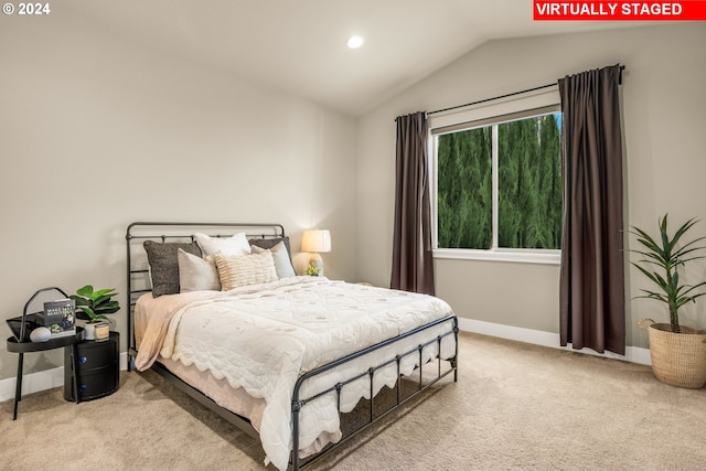 carpeted bedroom featuring vaulted ceiling