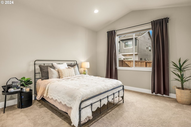 carpeted bedroom with lofted ceiling