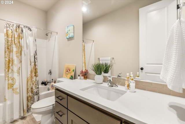 full bathroom featuring shower / bath combo, vanity, and toilet