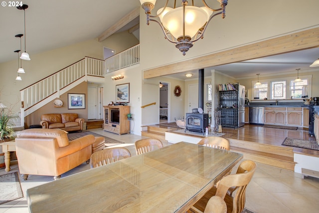 tiled dining space with an inviting chandelier, a wood stove, and ornamental molding