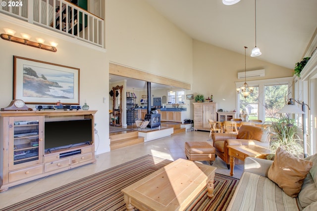 living room with a wall mounted air conditioner, a wood stove, high vaulted ceiling, light tile patterned floors, and a notable chandelier