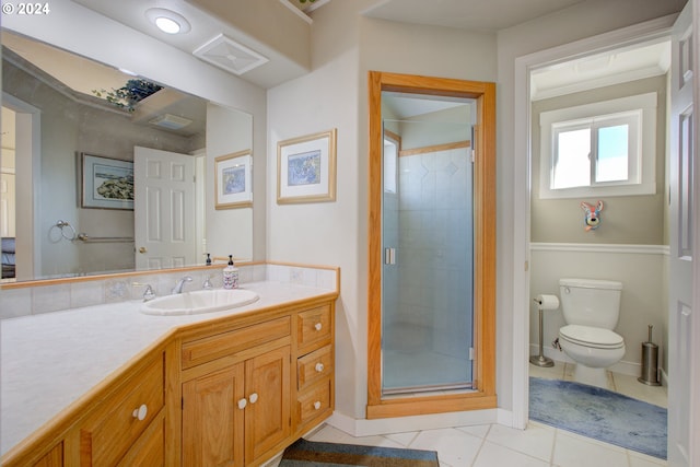 bathroom featuring tile patterned flooring, vanity, toilet, and walk in shower