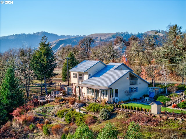 14115 N Bank Rd, Roseburg, OR 97470 - back of property with metal roof and a deck with mountain view