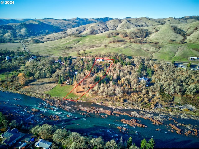 bird's eye view featuring a water and mountain view