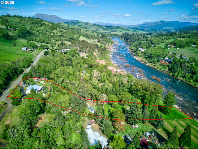 14115 N Bank Rd, Roseburg, OR 97470 - aerial view of property and surrounding area featuring property boundaries highlighted and a water and mountain view