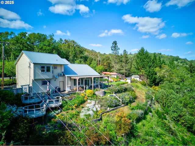 14115 N Bank Rd, Roseburg, OR 97470 - rear view of house with metal roof and a wooded view