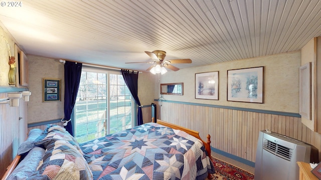 bedroom featuring ceiling fan and wooden ceiling