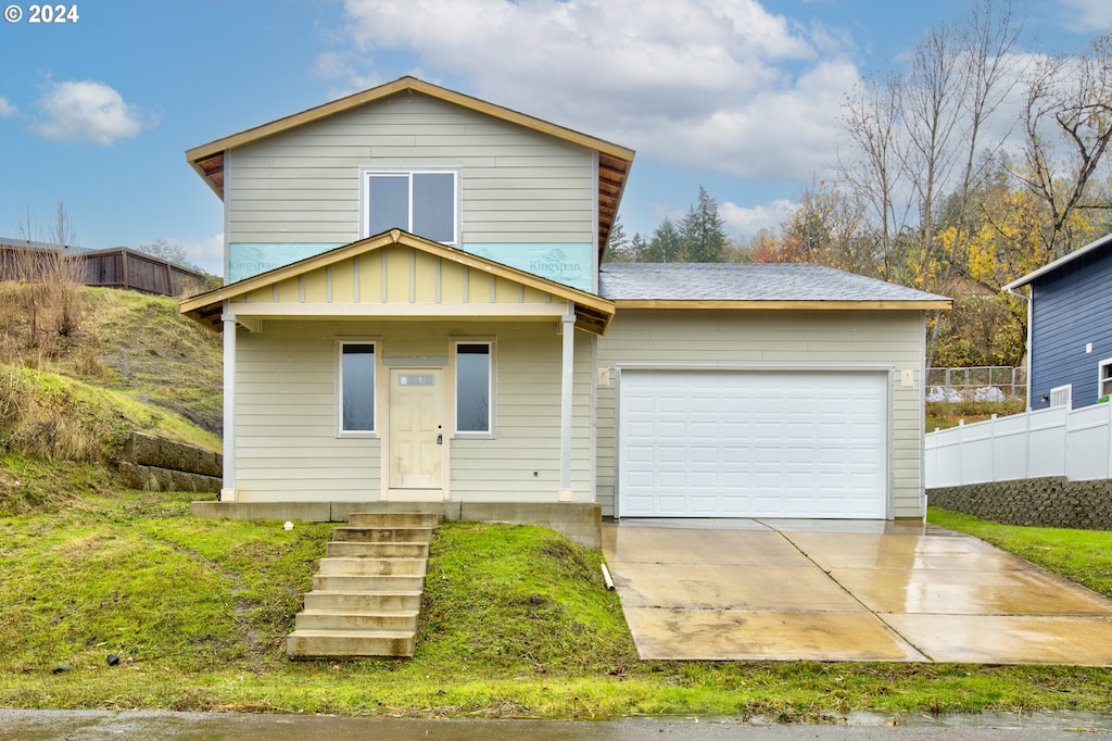 view of front of home with covered porch and a garage