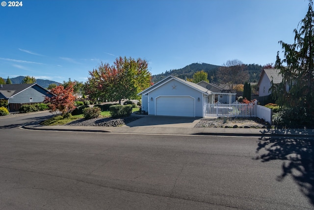 view of front of home featuring a garage and a mountain view