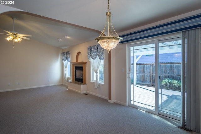 unfurnished living room with ceiling fan, carpet flooring, and a wealth of natural light