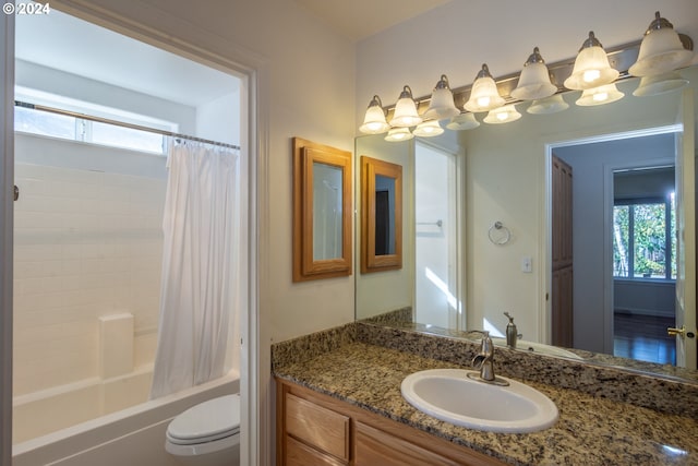 full bathroom with vanity, shower / tub combo with curtain, toilet, and plenty of natural light