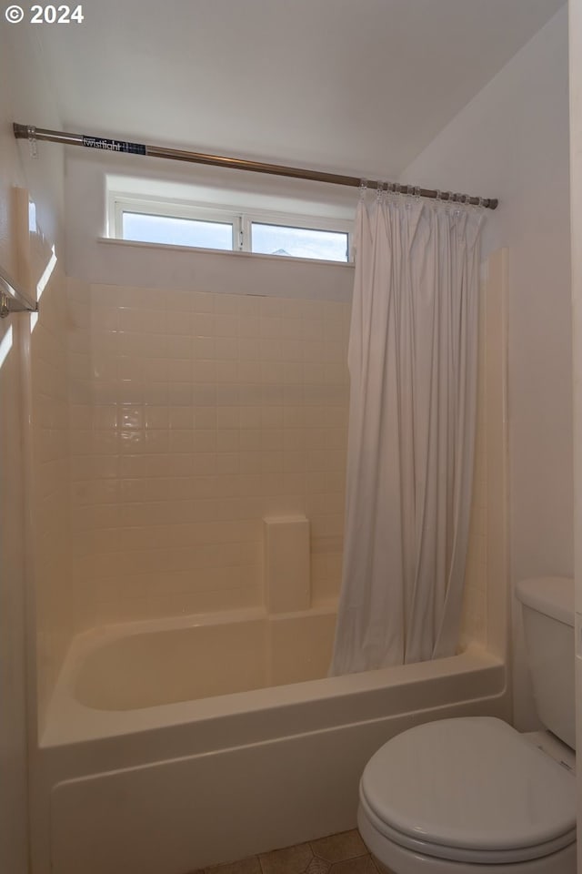 bathroom with shower / tub combo with curtain, toilet, and plenty of natural light