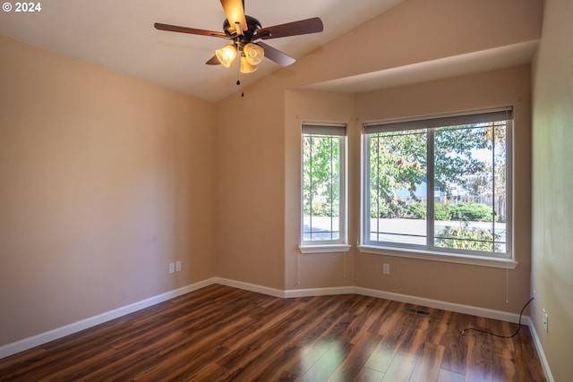 empty room with lofted ceiling, dark wood-type flooring, and ceiling fan