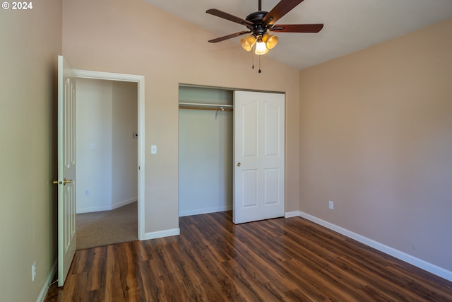 unfurnished bedroom featuring lofted ceiling, a closet, dark wood-type flooring, and ceiling fan