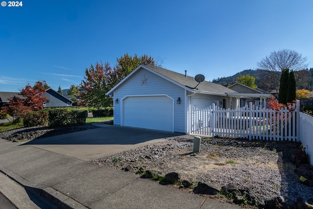 ranch-style home with a mountain view and a garage