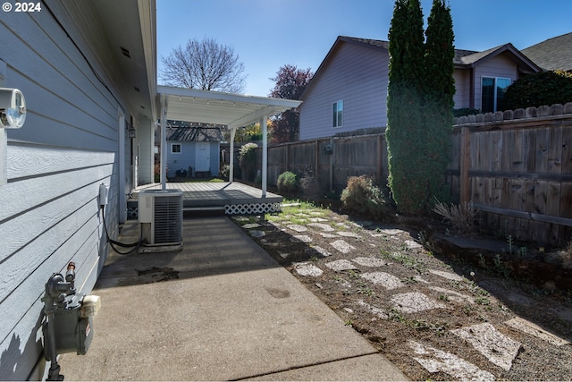 exterior space with a patio area, a deck, and central AC unit