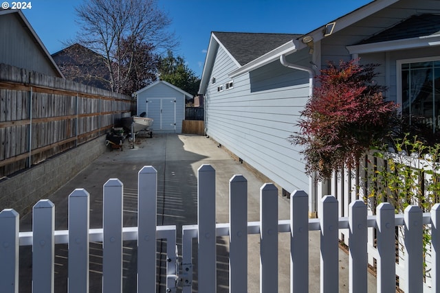 view of side of property with a shed and a patio