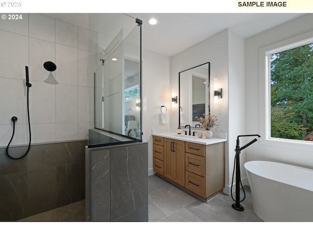 bathroom with tile patterned flooring, vanity, and shower with separate bathtub