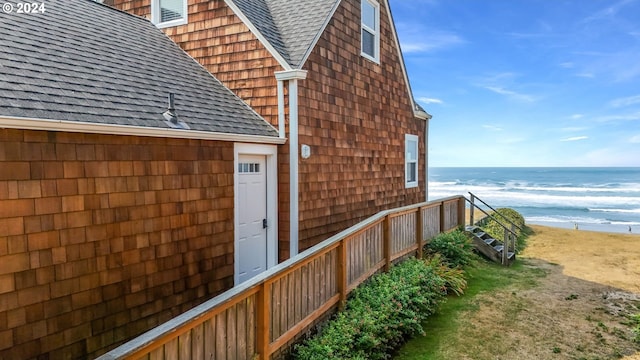 view of side of property with a view of the beach and a water view