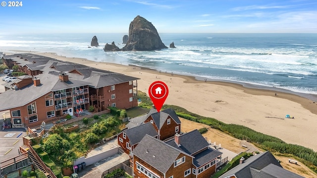 aerial view featuring a view of the beach and a water view