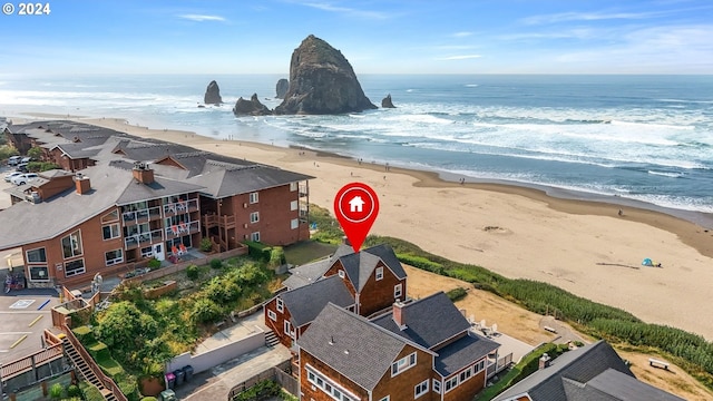 bird's eye view featuring a water view and a view of the beach