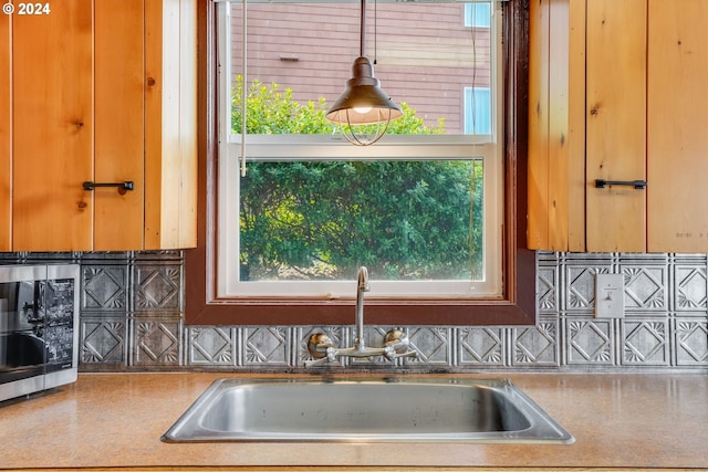 kitchen featuring plenty of natural light, tasteful backsplash, and sink