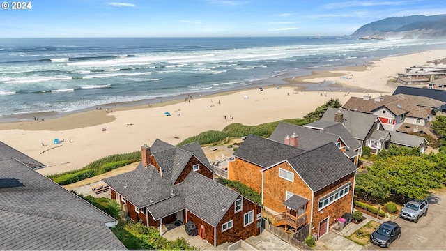 birds eye view of property with a water view and a view of the beach