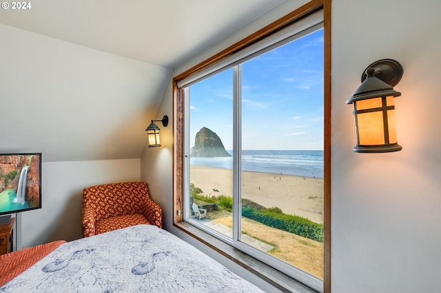 bedroom featuring a water view, multiple windows, and lofted ceiling