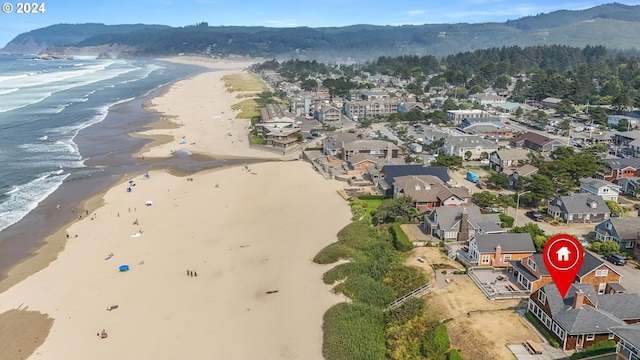 bird's eye view featuring a water and mountain view and a view of the beach