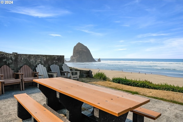 exterior space with a water view and a view of the beach