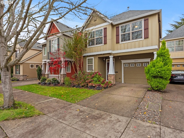 craftsman house with a front lawn and a garage