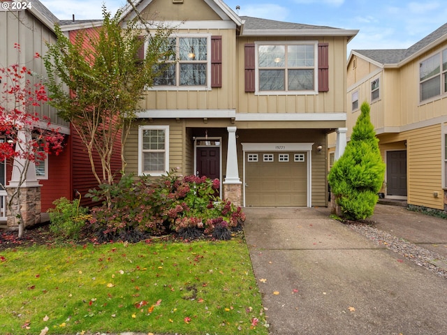 craftsman-style house featuring a garage and a front lawn