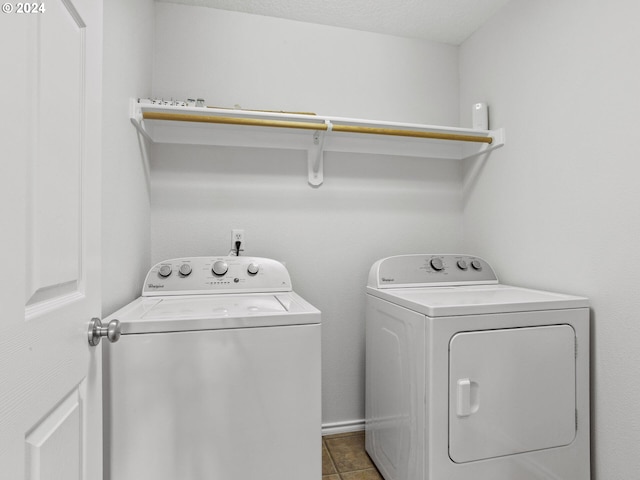 15771 SW Harvester Ln, Sherwood, OR 97140 - washroom featuring washing machine and clothes dryer and light tile patterned floors
