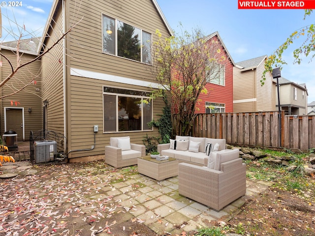 rear view of house featuring outdoor lounge area, central AC, and a patio