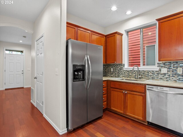 15771 SW Harvester Ln, Sherwood, OR 97140 - kitchen featuring appliances with stainless steel finishes, a sink, dark wood-style flooring, tasteful backsplash, and recessed lighting