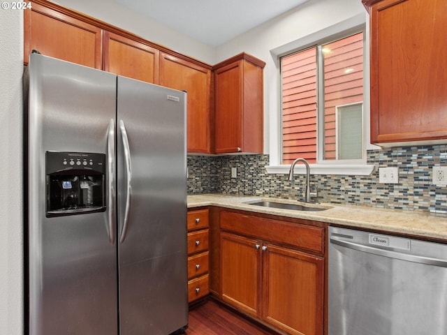 15771 SW Harvester Ln, Sherwood, OR 97140 - kitchen with appliances with stainless steel finishes, a sink, decorative backsplash, and brown cabinets